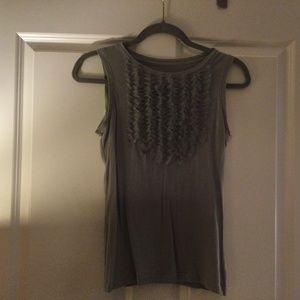 Gray sleeveless blouse with tuxedo type design on